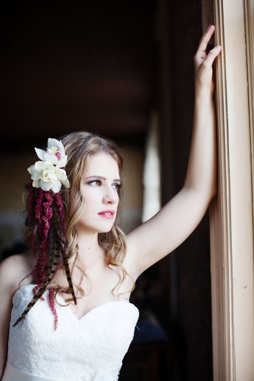 gardenia, orchid, and amaranthus headpiece with pheasant feathers by Anastasia Ehlers, photo by Anne Nunn