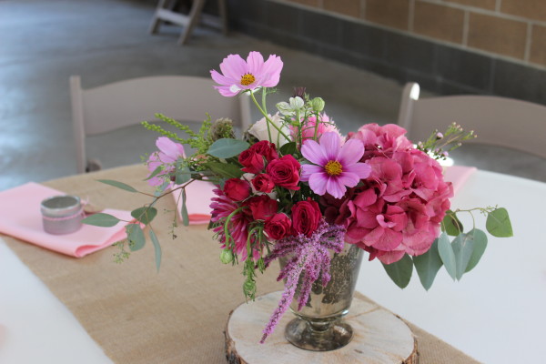 pink hydrangea centerpiece on wood slice in mercury glass by Anastasia Ehlers