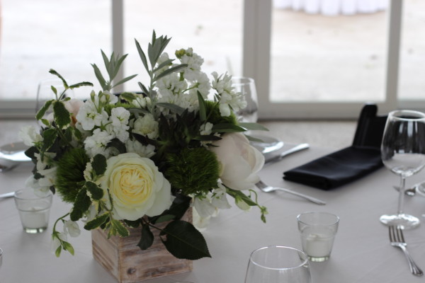 green and white centerpiece in a wood box by anastasia floral design