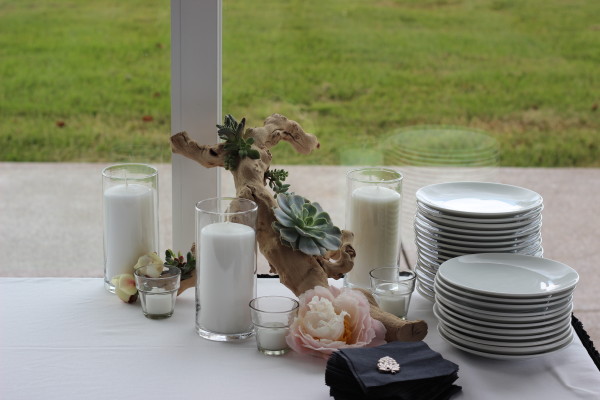 succulents, candles, and grape wood with loose peonies by anastasia floral